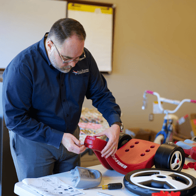 Our team member, Wes, putting together a toy for Families Helping Families