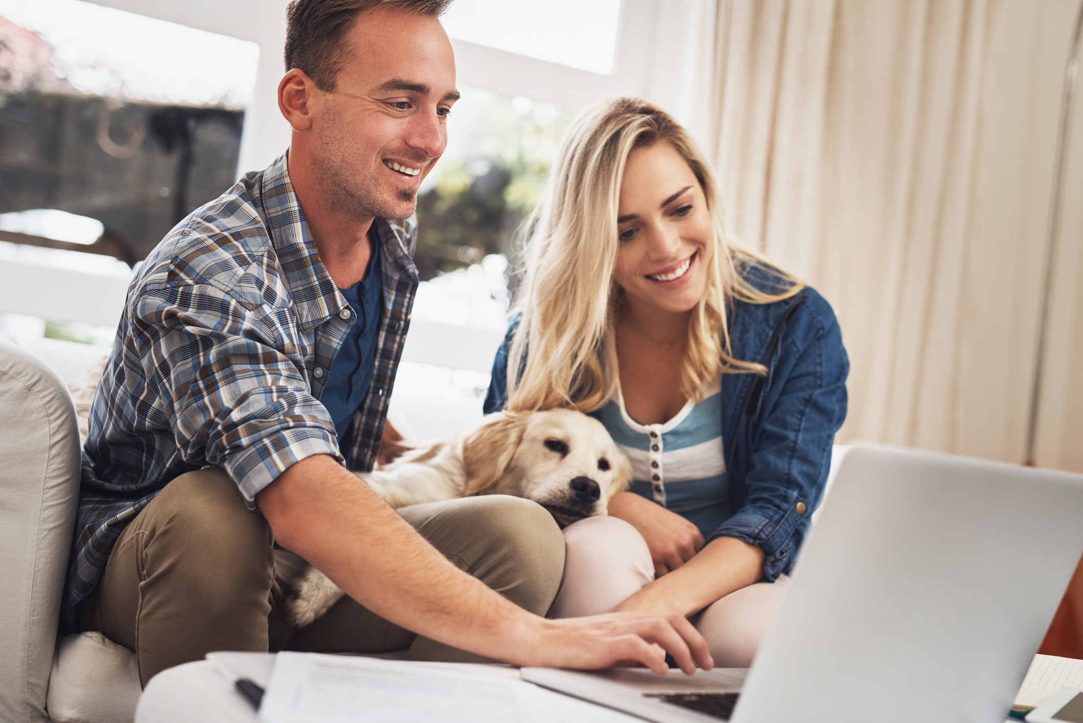 couple with puppy on laptop